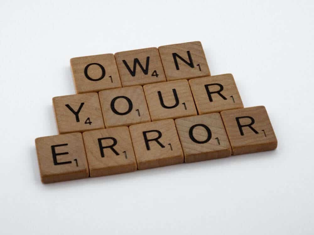 Scrabble blocks spelling out own your error